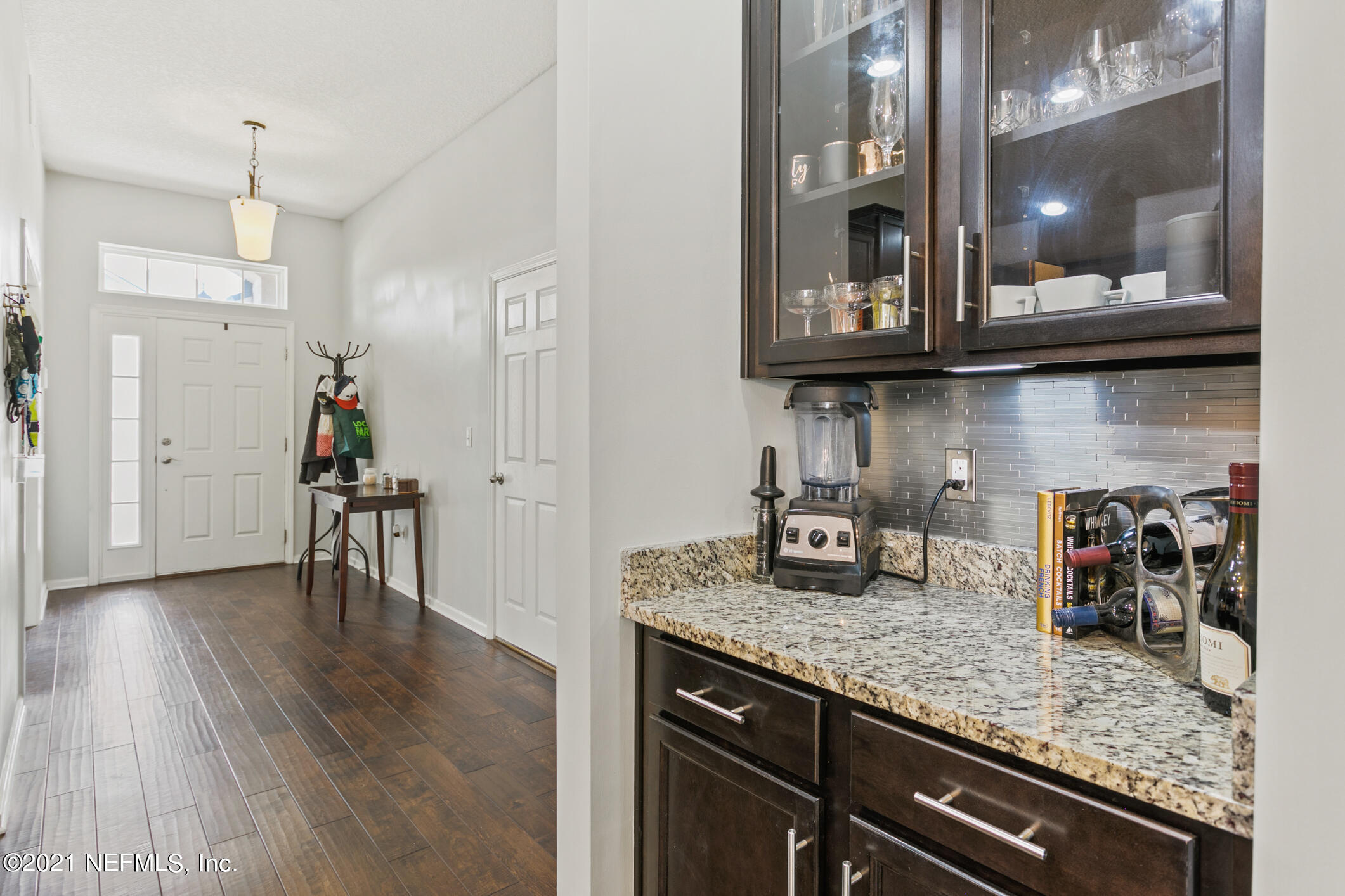 1365 Royal Dornoch Drive Jacksonville, FL 32221 - Photo 12 of 32 a kitchen with granite countertop a stove a refrigerator and wooden floor