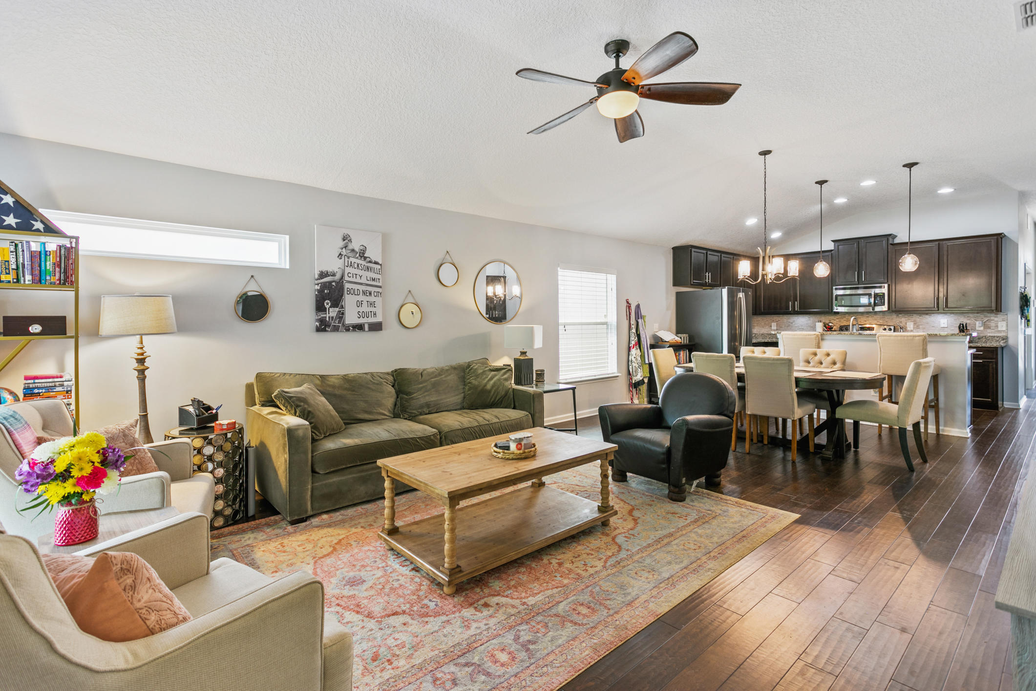 1365 Royal Dornoch Drive Jacksonville, FL 32221 - Photo 16 of 32 a living room with furniture kitchen view and a chandelier