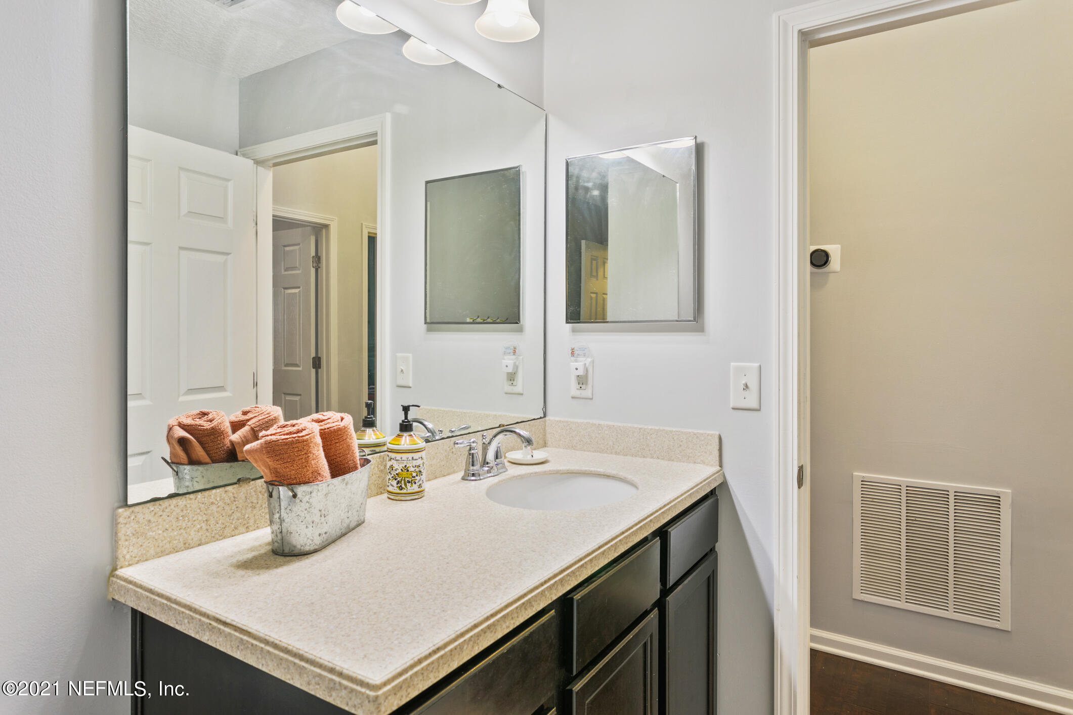 1365 Royal Dornoch Drive Jacksonville, FL 32221 - Photo 18 of 32 a bathroom with a sink and a mirror