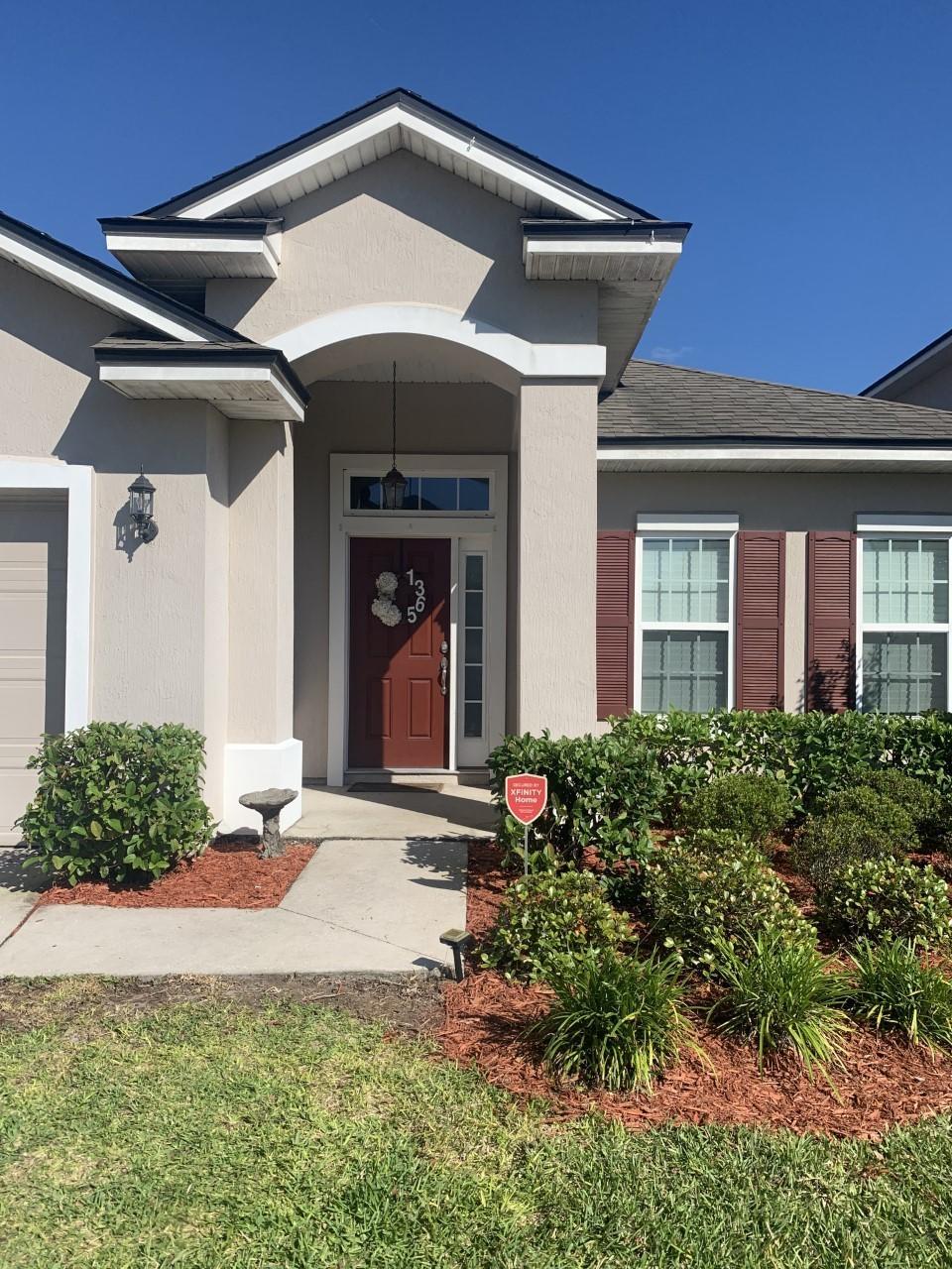 1365 Royal Dornoch Drive Jacksonville, FL 32221 - Photo 2 of 32 a front view of a house with garden
