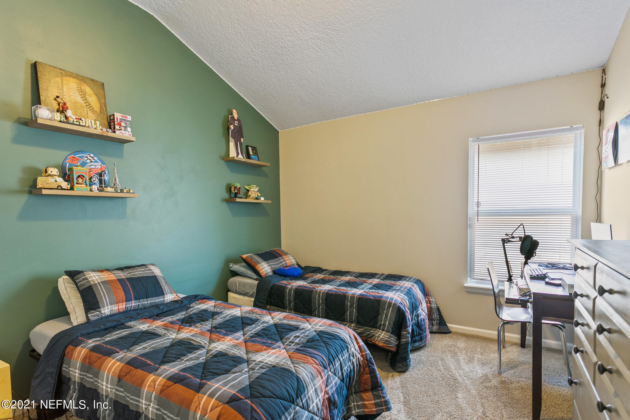 1365 Royal Dornoch Drive Jacksonville, FL 32221 - Photo 21 of 32 a bedroom with two beds and a chair