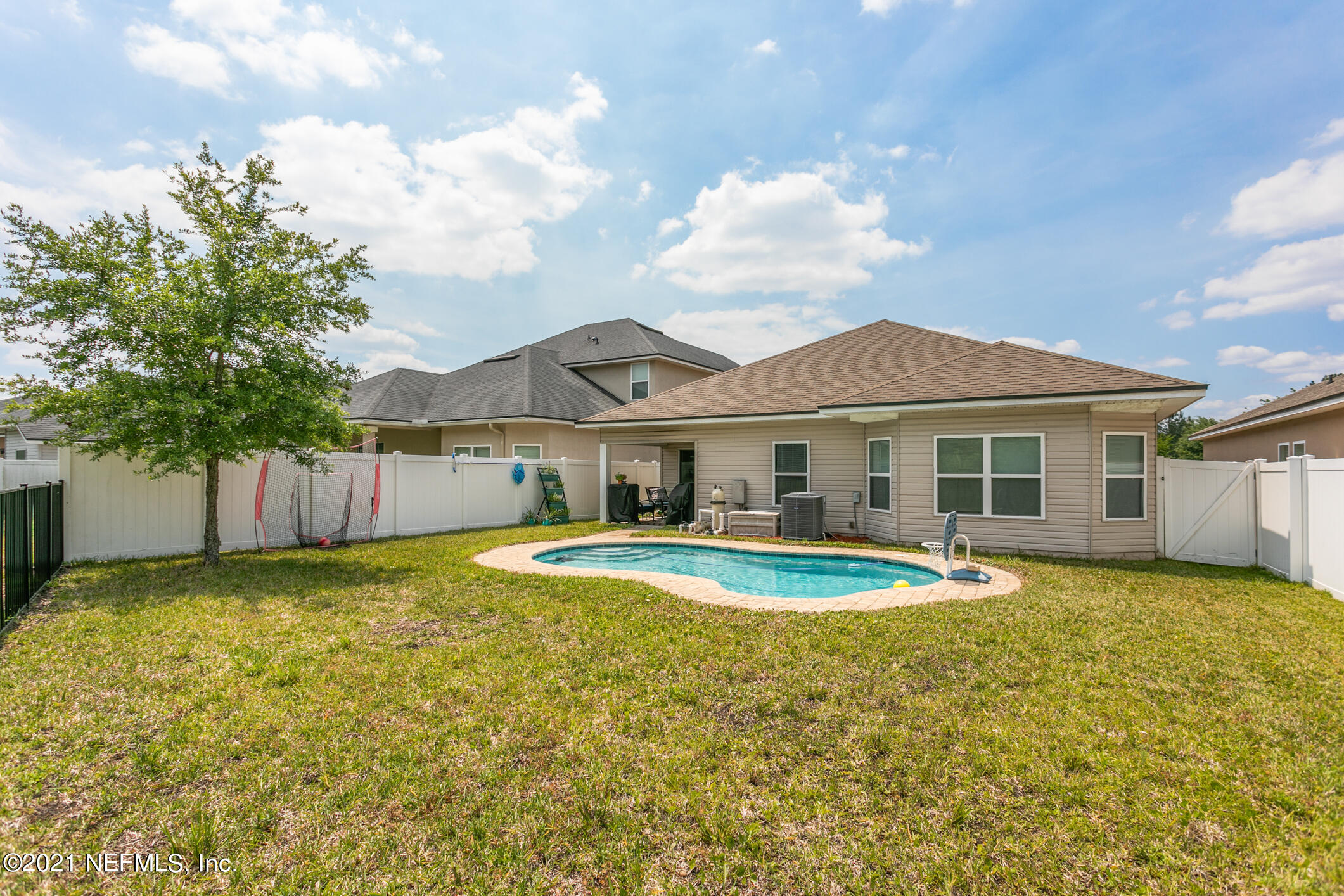 1365 Royal Dornoch Drive Jacksonville, FL 32221 - Photo 31 of 32 a view of a house with a swimming pool and a yard