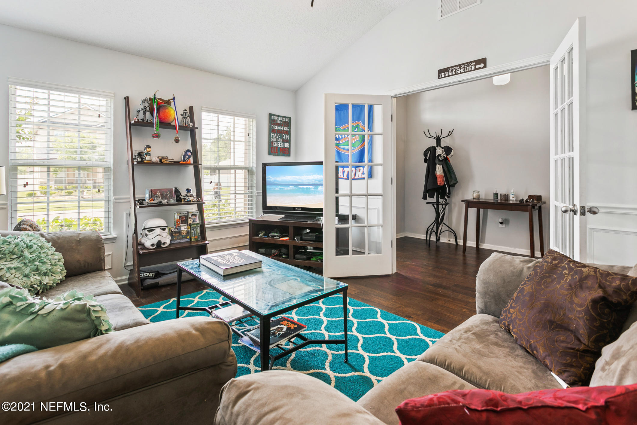 1365 Royal Dornoch Drive Jacksonville, FL 32221 - Photo 7 of 32 a living room with furniture and a flat screen tv
