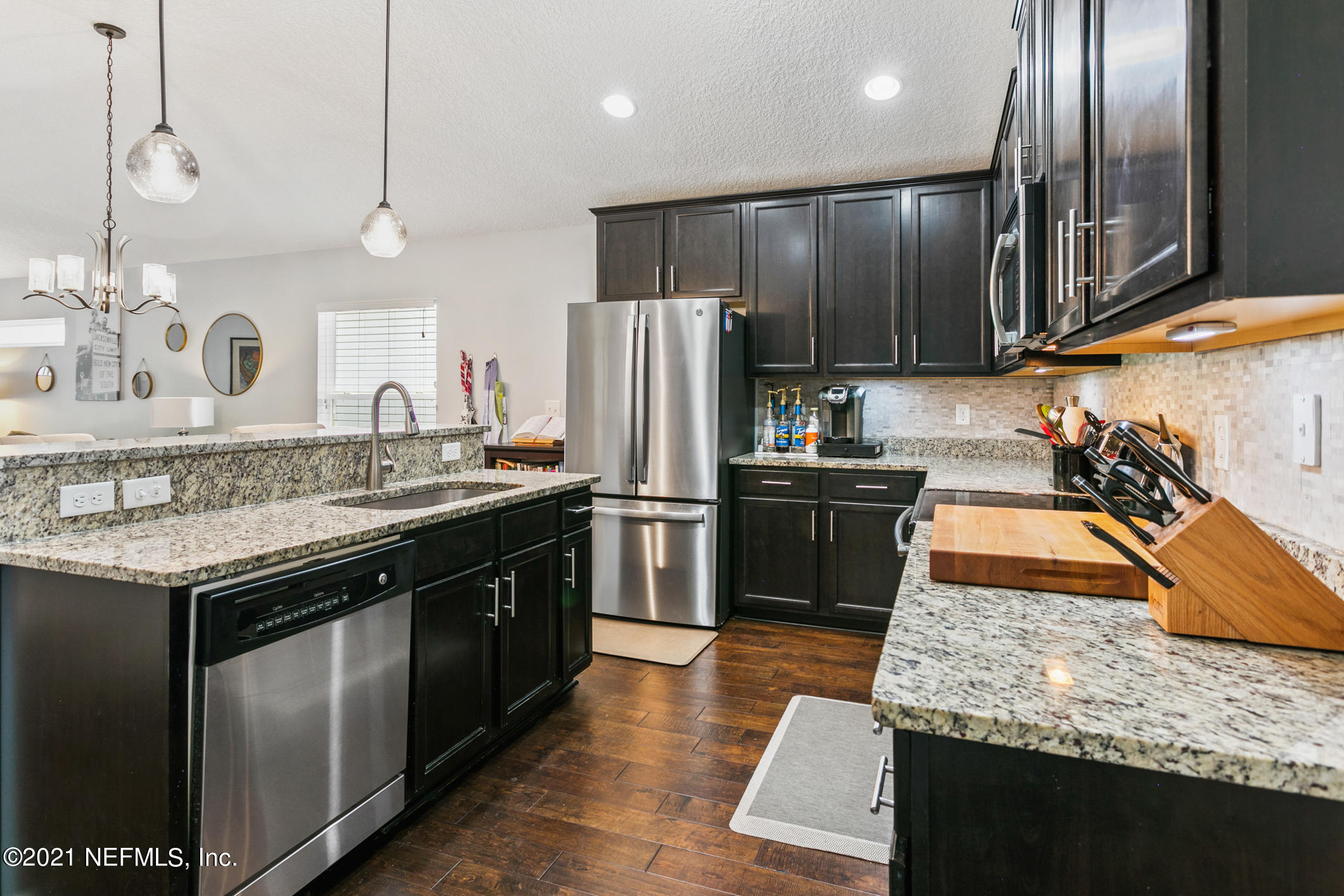 1365 Royal Dornoch Drive Jacksonville, FL 32221 - Photo 9 of 32 a kitchen with a sink stove and refrigerator