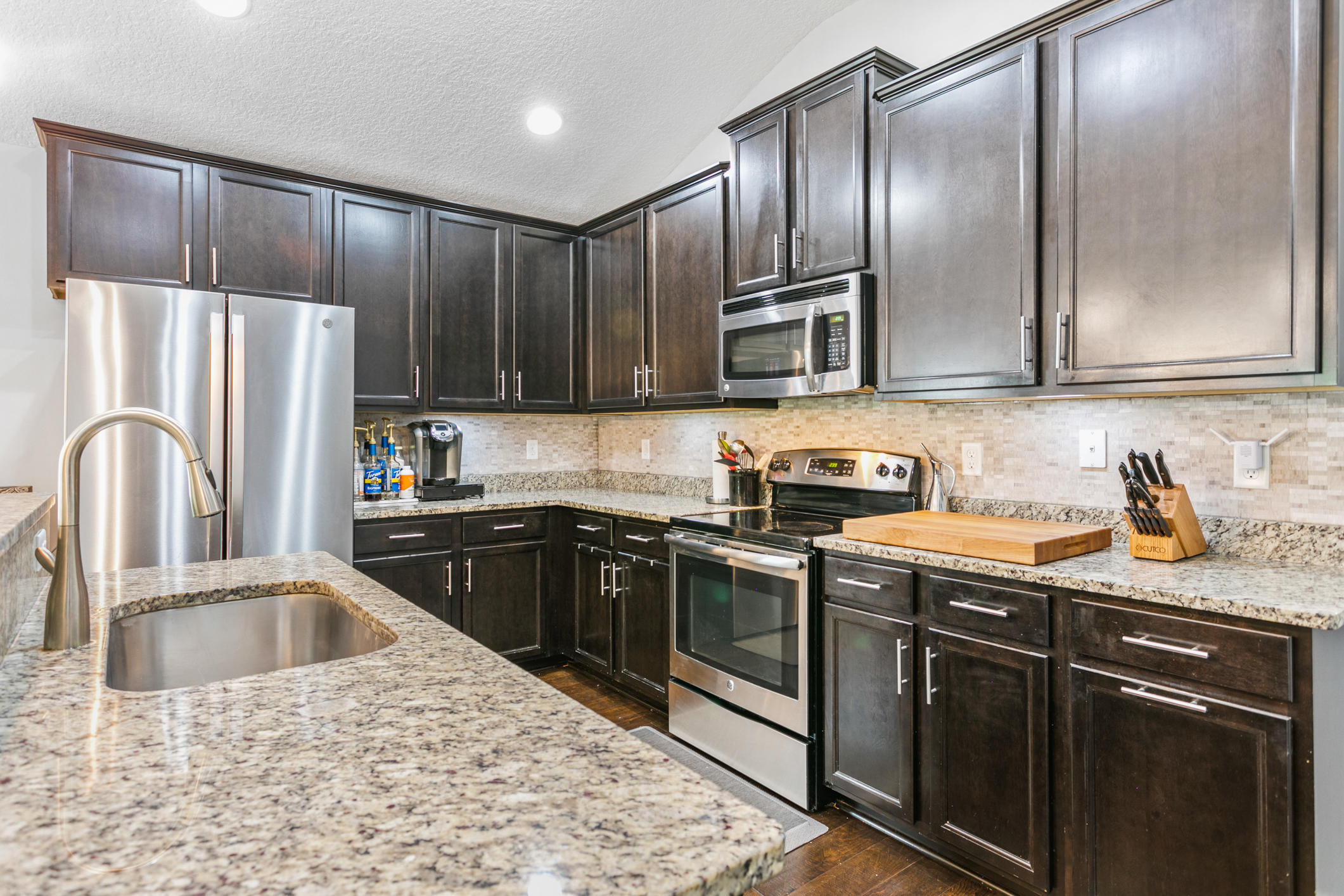 1365 Royal Dornoch Drive Jacksonville, FL 32221 - Photo 10 of 32 a kitchen with granite countertop a refrigerator sink and stove
