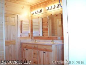 212 Campbell Creek Road Maggie Valley, NC 28751 - Photo 7 of 9 a bathroom with a sink and a mirror
