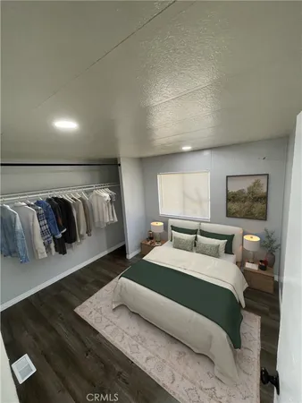 a bedroom with a bed and a night stand