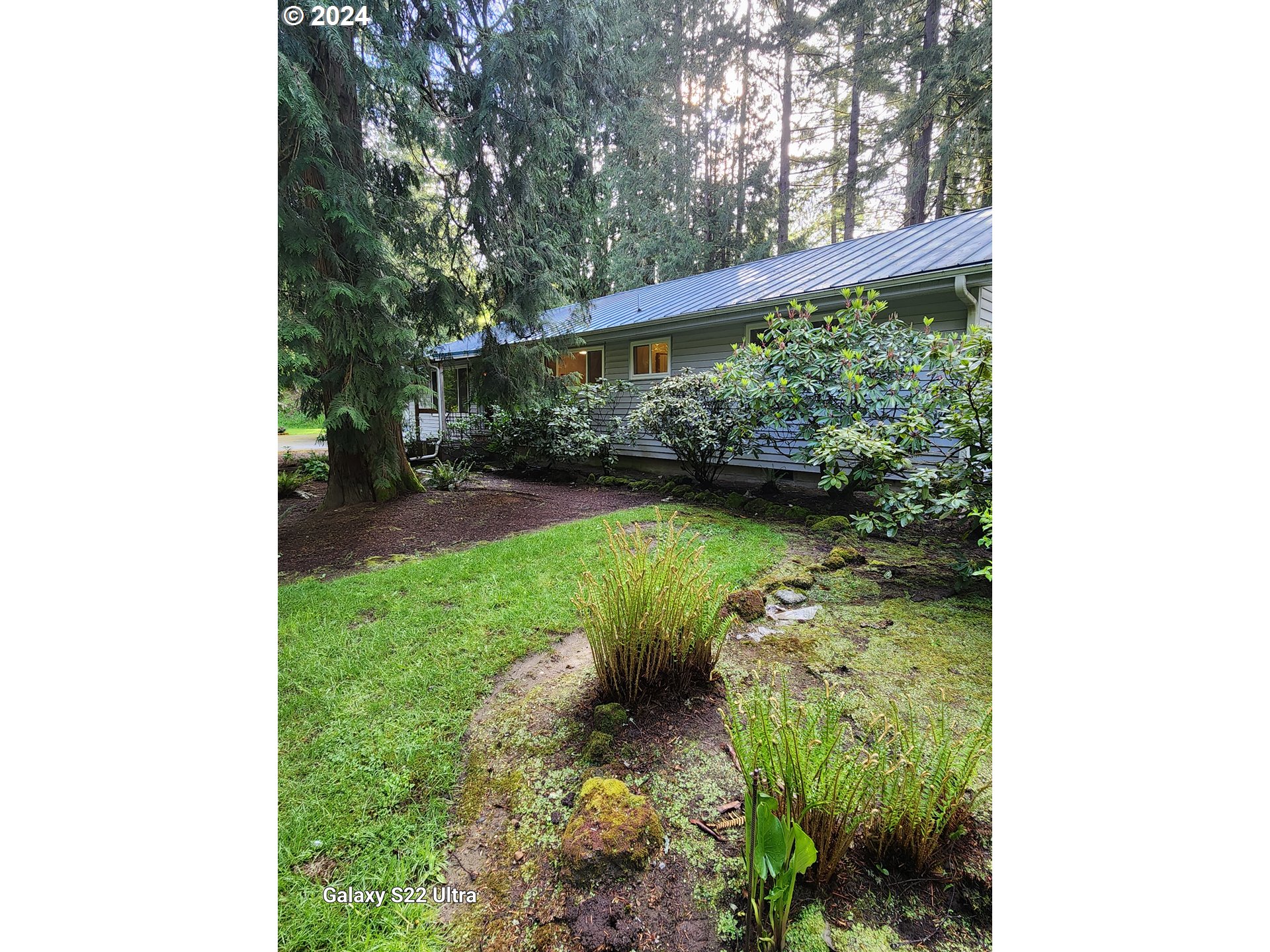 19216 South Neil Road Estacada, OR 97023 - Photo 2 of 33 a view of a garden with a bench