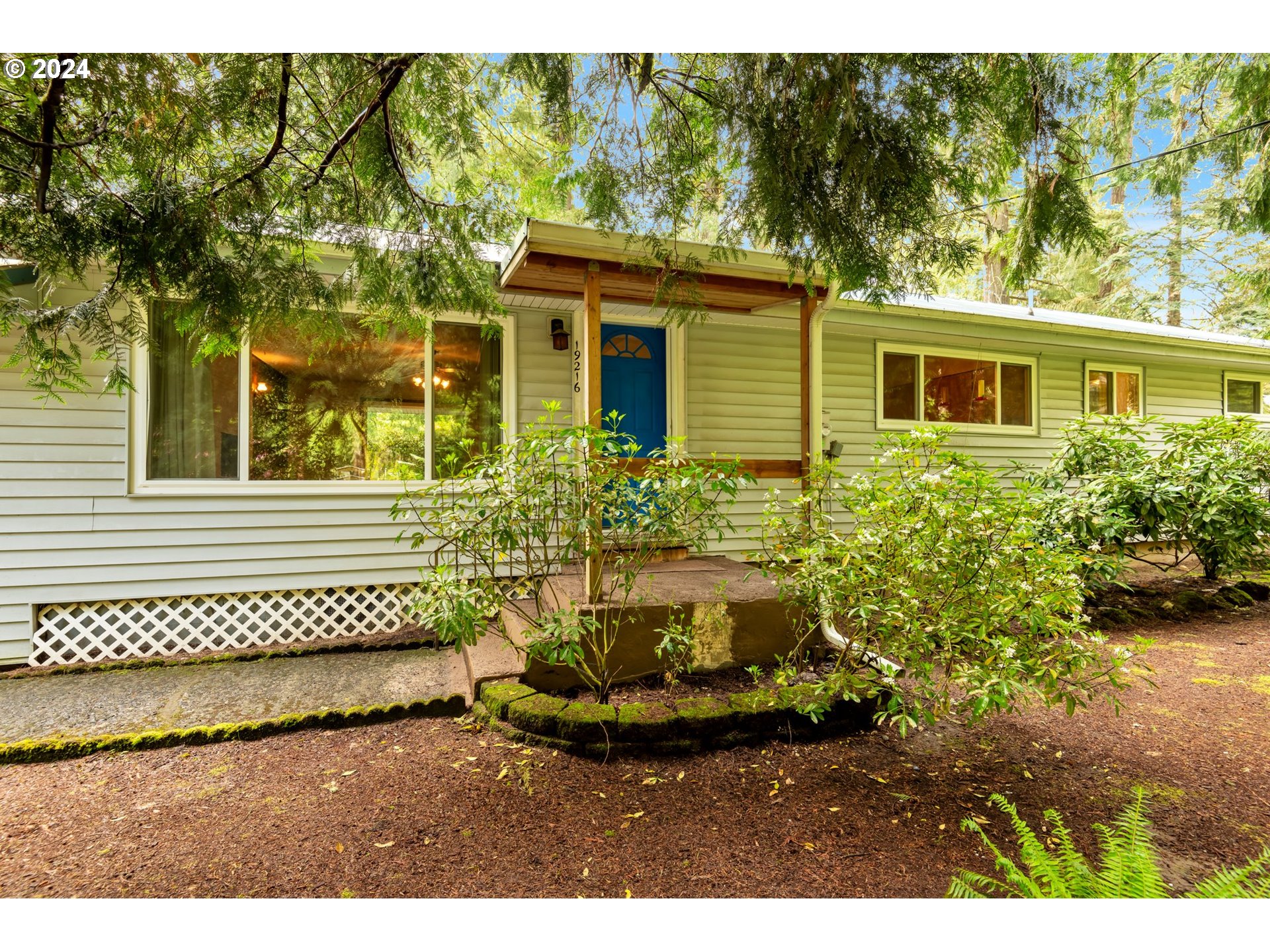 19216 South Neil Road Estacada, OR 97023 - Photo 4 of 33 a view of a house with a small yard and wooden fence