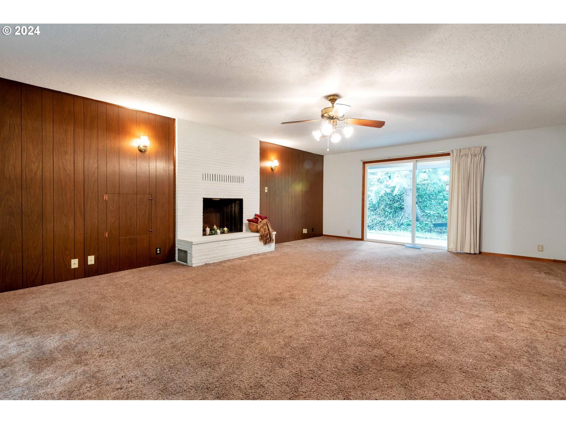 19216 South Neil Road Estacada, OR 97023 - Photo 5 of 33 a view of a livingroom with a fireplace a ceiling fan and window