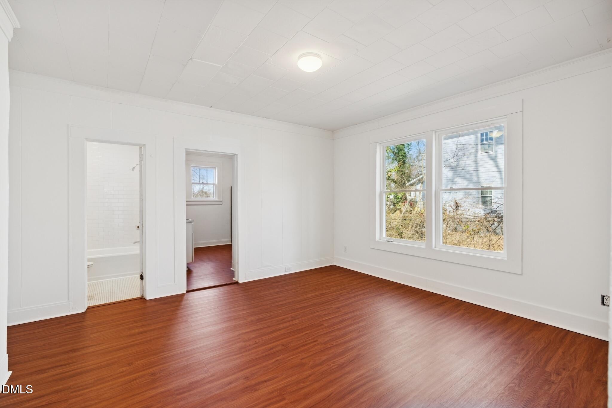 705 North Driver Street Durham, NC 27703 - Photo 13 of 46 an empty room with wooden floor and windows