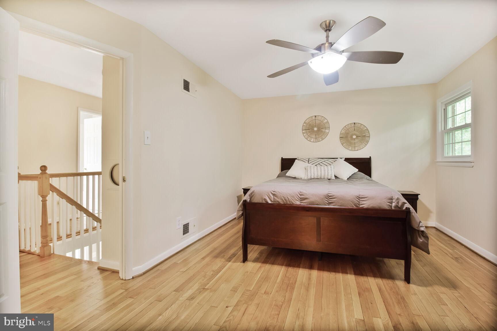 10611 Meadowhill Road Silver Spring, MD 20901 - Photo 16 of 29 a bedroom with a large bed and a chandelier