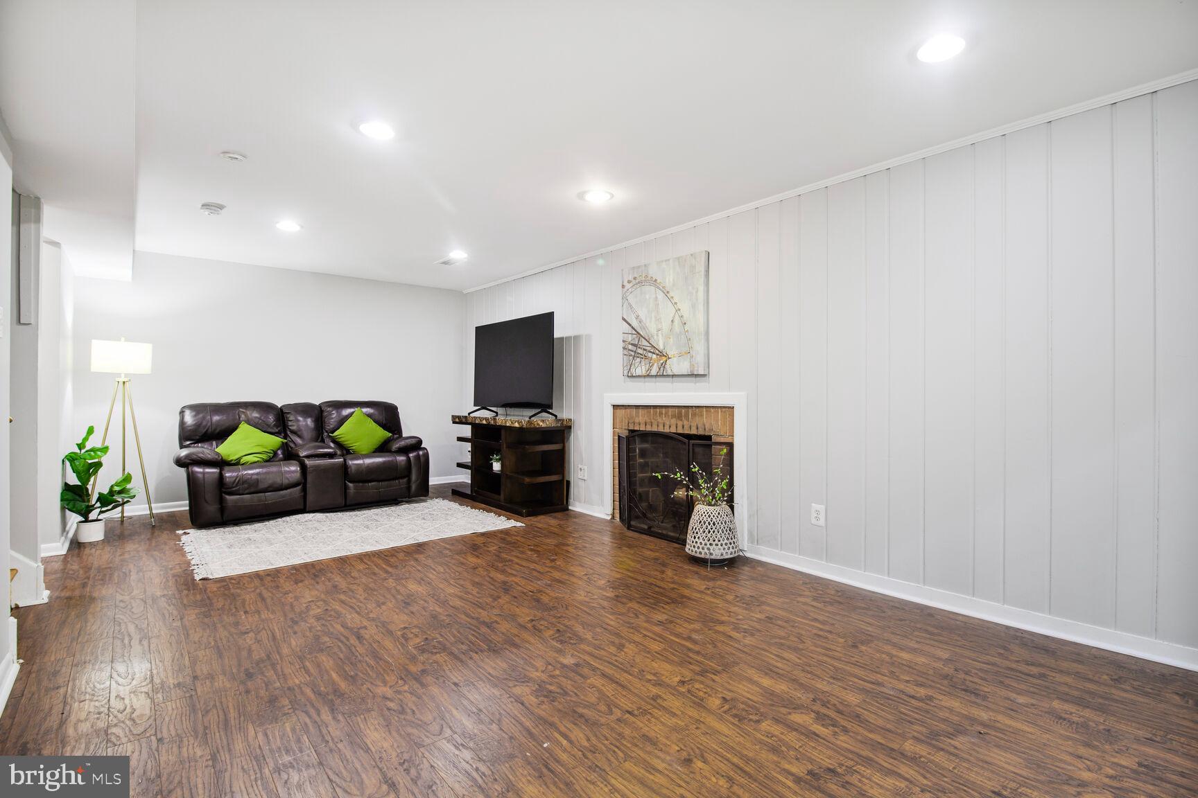 10611 Meadowhill Road Silver Spring, MD 20901 - Photo 24 of 29 a living room with furniture a fireplace and a potted plant