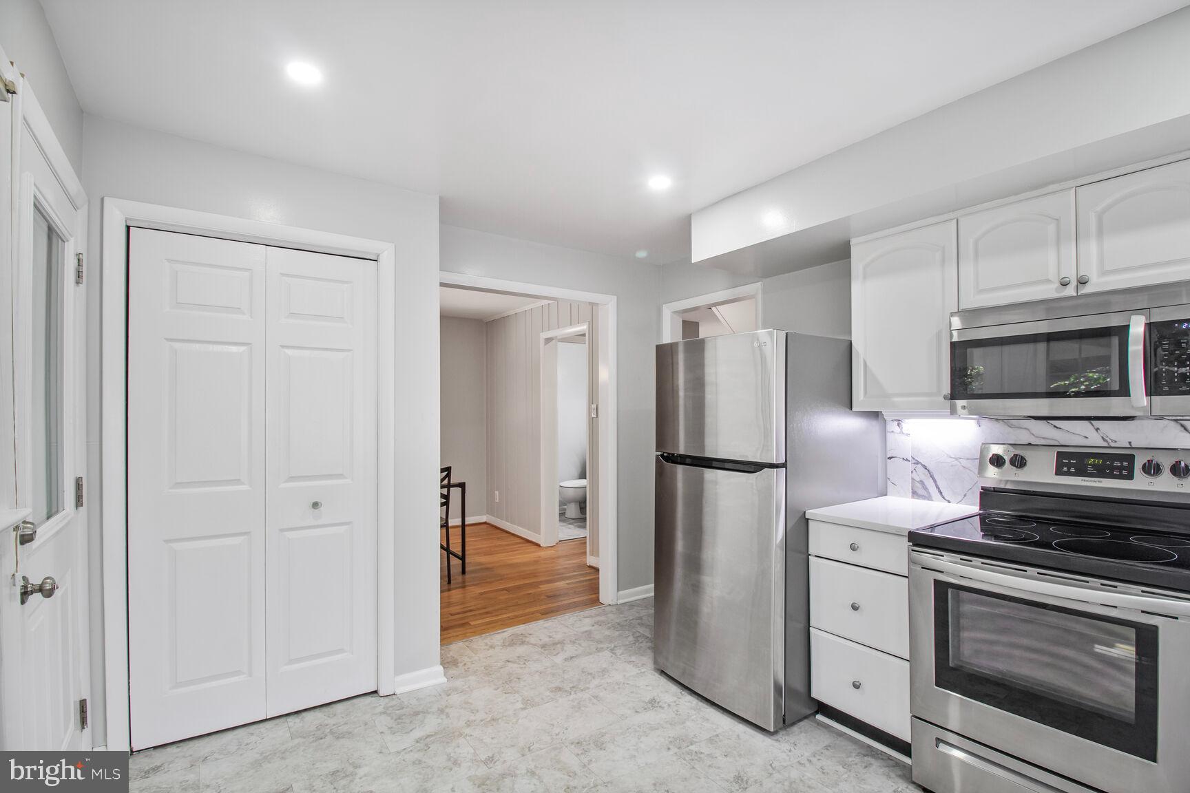 10611 Meadowhill Road Silver Spring, MD 20901 - Photo 6 of 29 a kitchen with stainless steel appliances a refrigerator stove and microwave