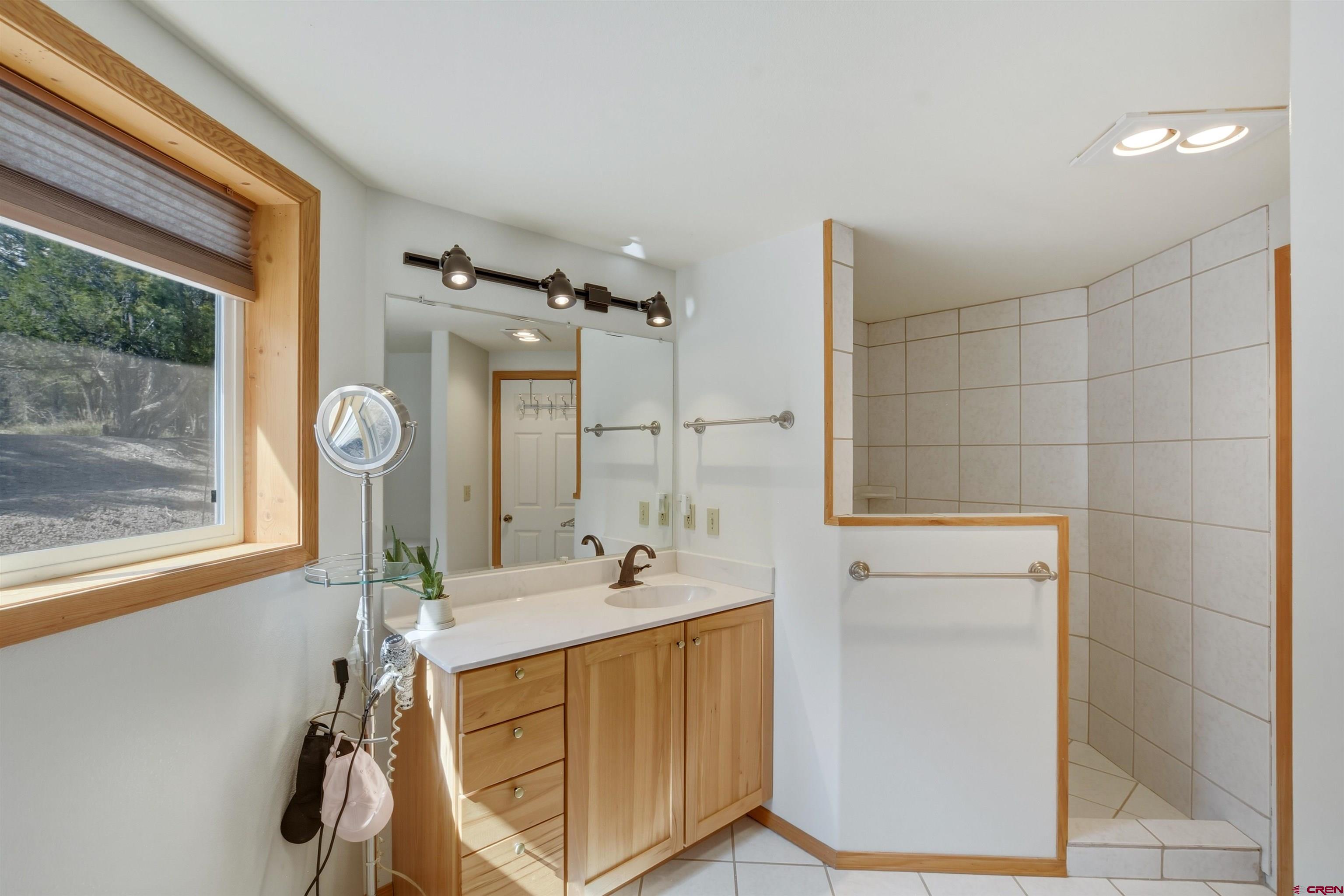 36283 Rd K.3 Mancos, CO 81328 - Photo 20 of 37 a bathroom with a double vanity sink mirror and shower