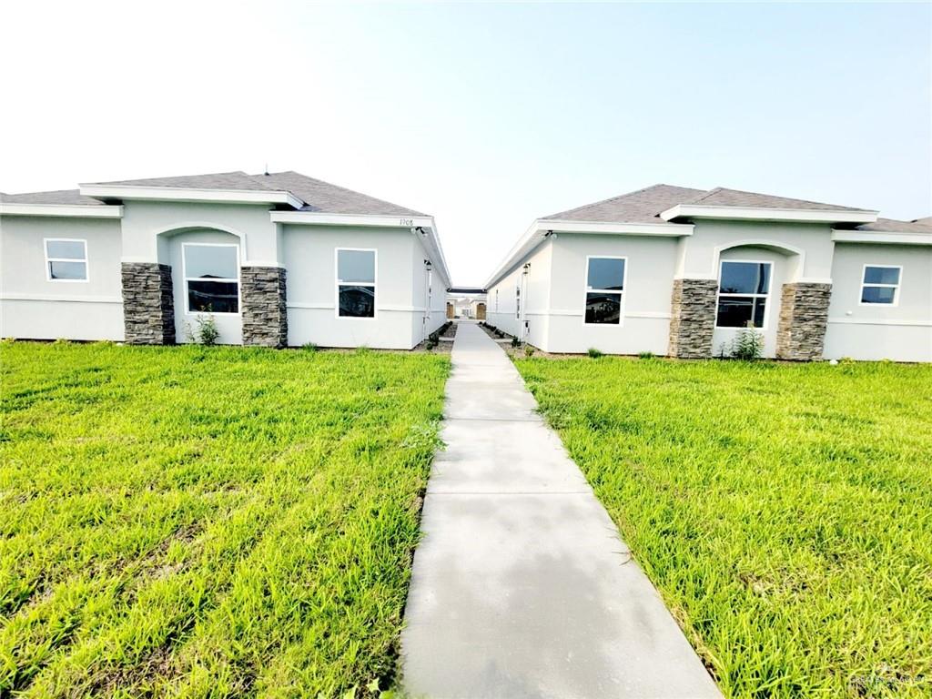 a view of a house with a backyard