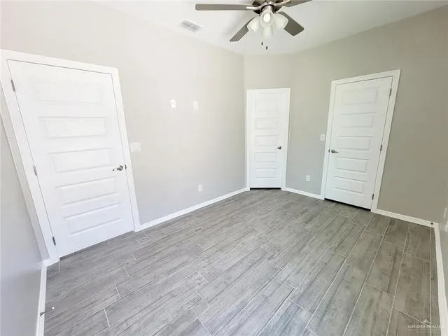 a view of walk in closet with wooden floor