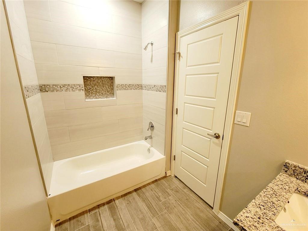 1908 Davenport Street, Unit 1 Weslaco, TX 78596 - Photo 16 of 21 a bathroom with a bathtub and shower