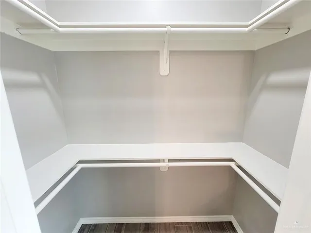 a kitchen with kitchen island granite countertop a sink cabinets a window and stainless steel appliances