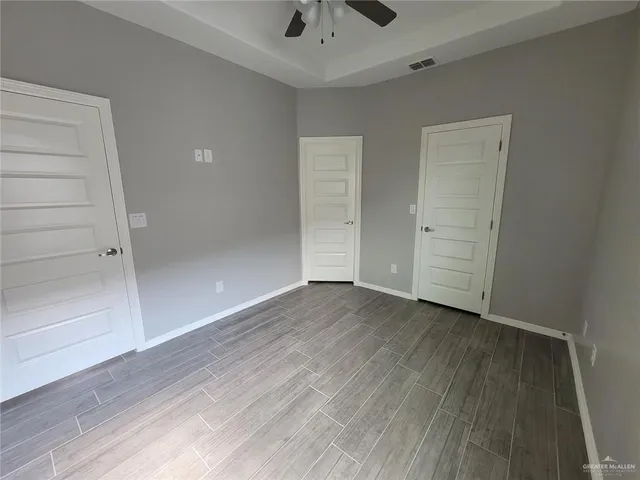 an empty room with wooden floor