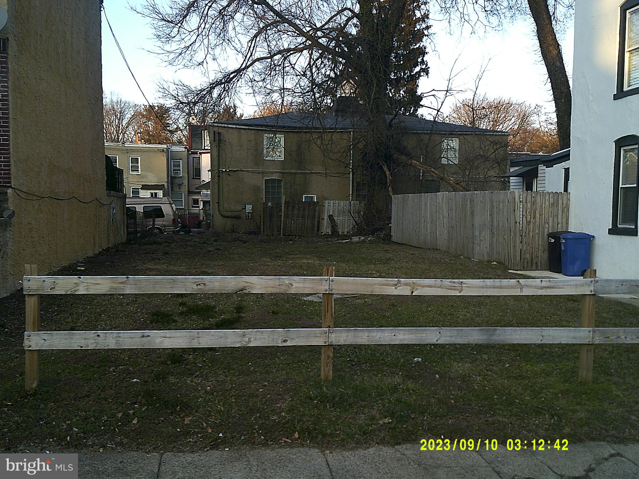 4995 Sheldon Street Philadelphia, PA 19144 - Photo 2 of 2 a view of backyard with wooden fence and large trees