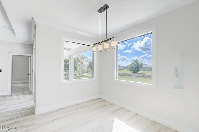 a view of an empty room with a window and closet