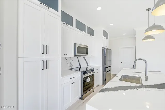 a kitchen with stainless steel appliances a refrigerator stove and sink