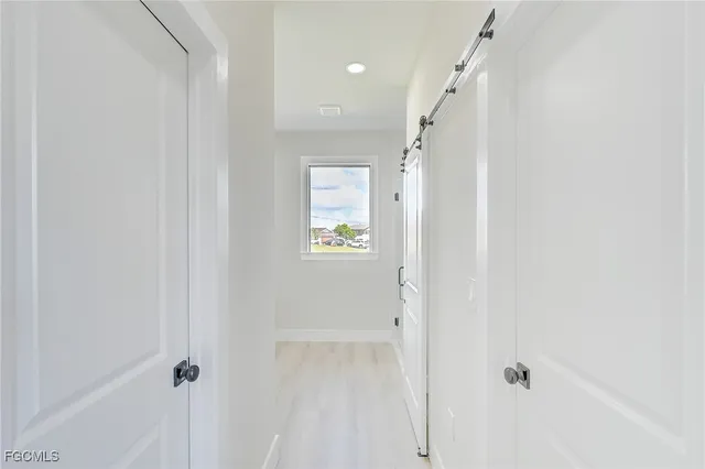 a view of a hallway with a white walls