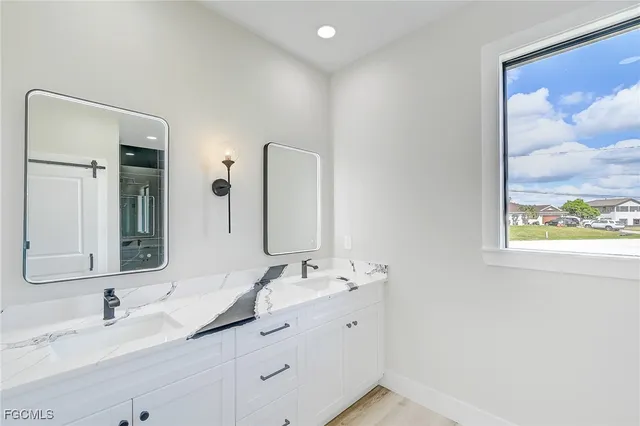 a bathroom with a double vanity sink and mirror