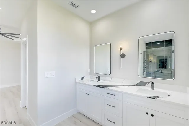 a bathroom with a double vanity sink and mirror