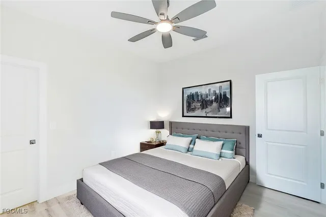 a bedroom with a bed and a painting on the wall