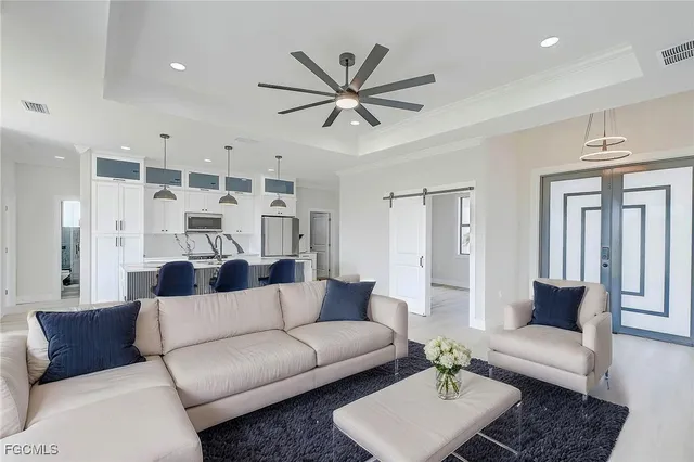 a view of a livingroom with furniture and a ceiling fan