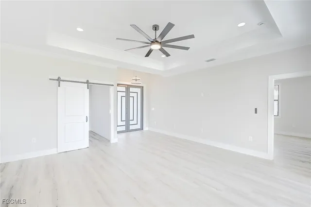 a view of a livingroom with a ceiling fan & hardwood floor