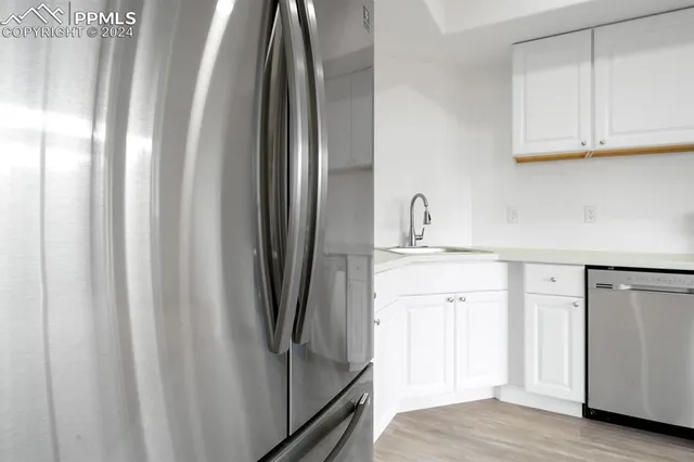 a kitchen with stainless steel appliances a refrigerator and cabinets