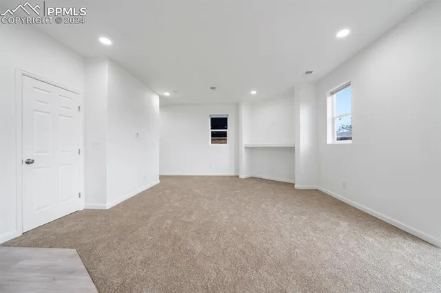 an empty room with a empty space and windows