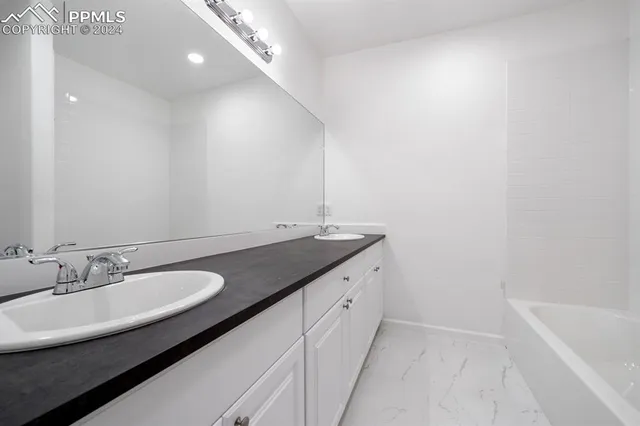 a bathroom with a sink and a bathtub