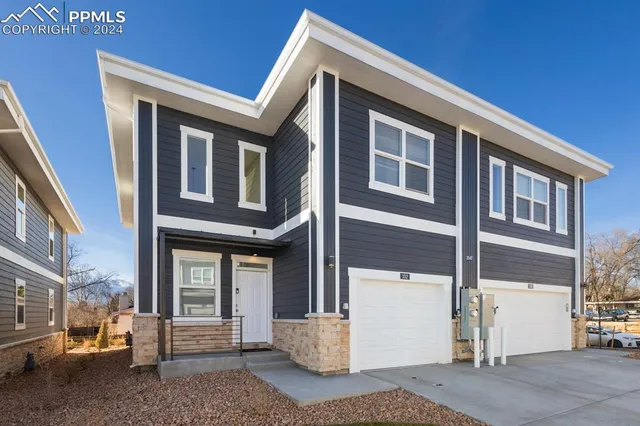 a front view of a house with a parking space
