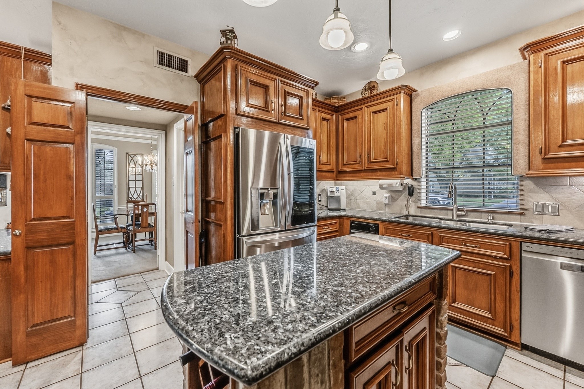 6047 Spring Creek Lane Spring, TX 77379 - Photo 16 of 50 Designed with timeless craftsmanship and everyday comfort in mind, the kitchen pairs furniture style cabinetry with rich natural textures and a warm, welcoming palette. Expansive prep space, premium appliances, an annually maintained reverse osmosis system, and a whole home water softener bring thoughtful functionality to the heart of the home.