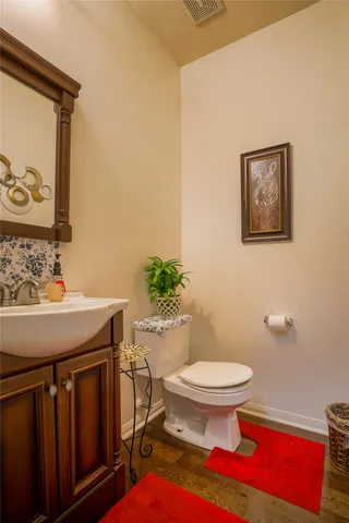 a bathroom with a sink a toilet and shower curtain