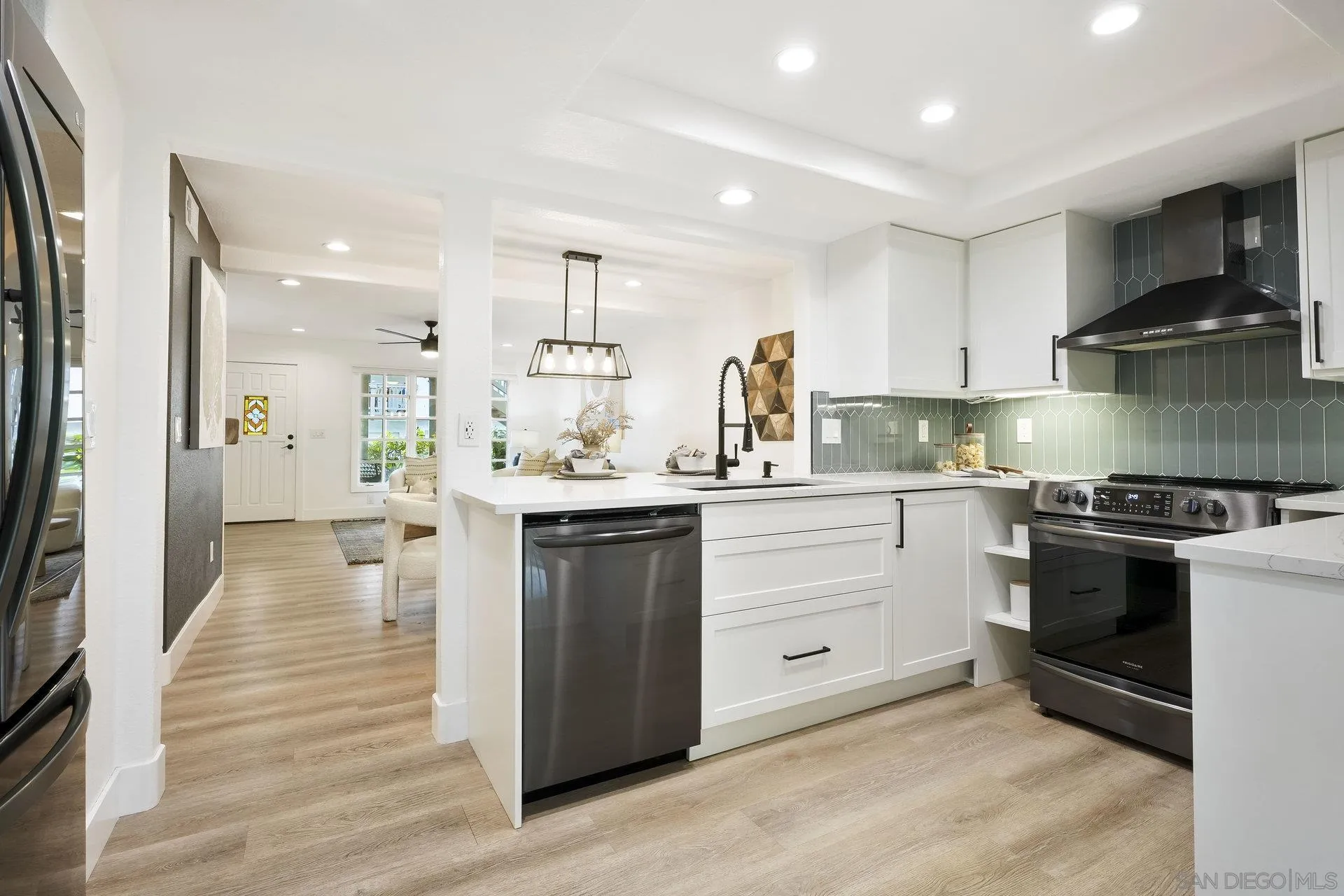 381 Playa Blanca Encinitas, CA 92024 - Photo 11 of 32 a kitchen with a sink stove and refrigerator