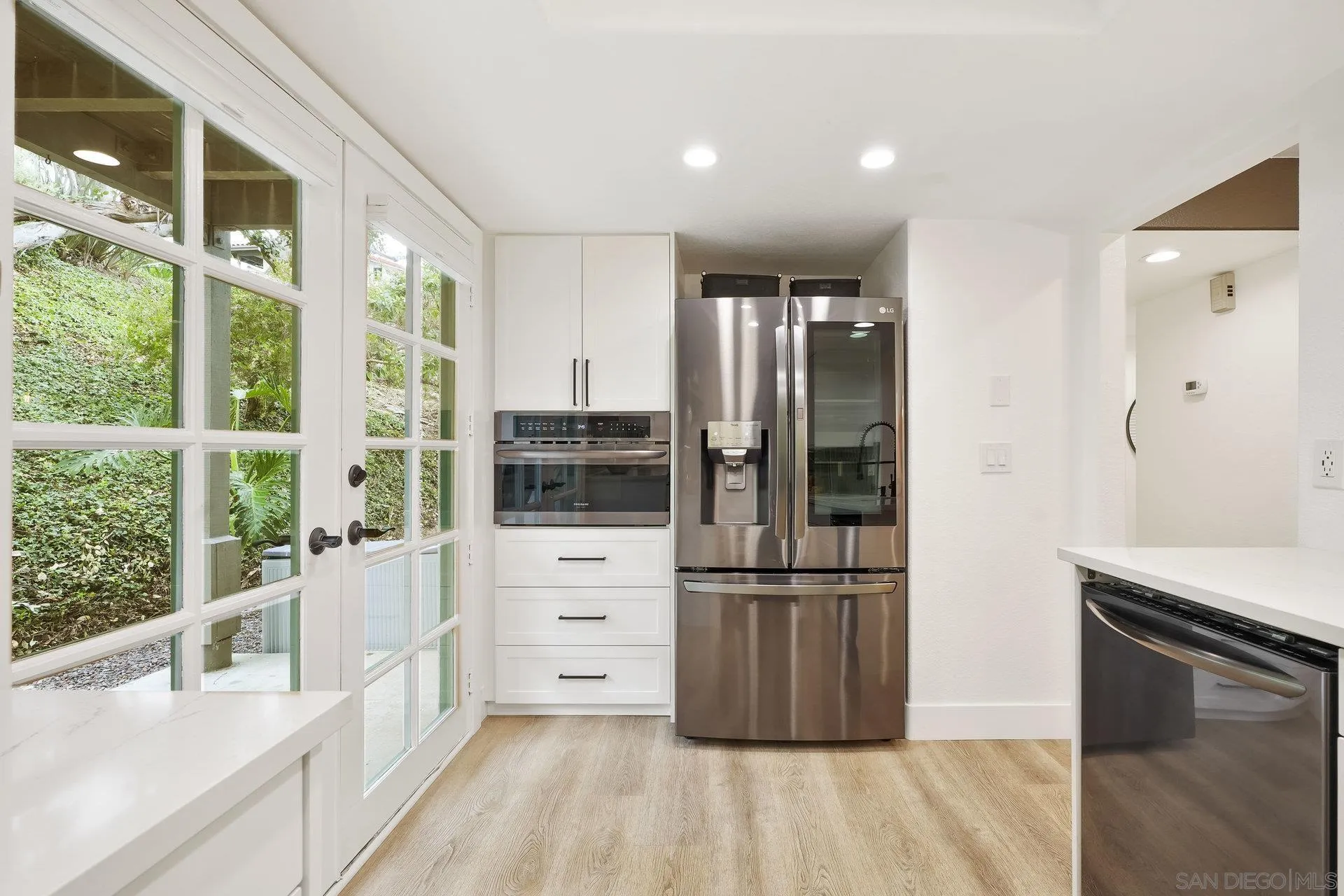 381 Playa Blanca Encinitas, CA 92024 - Photo 13 of 32 a kitchen with stainless steel appliances a refrigerator and a stove top oven