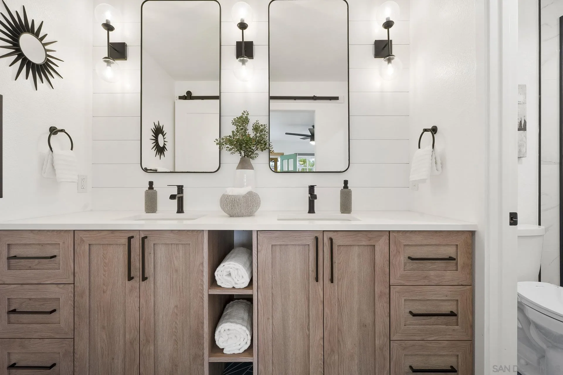 381 Playa Blanca Encinitas, CA 92024 - Photo 18 of 32 a bathroom with a sink and a mirror