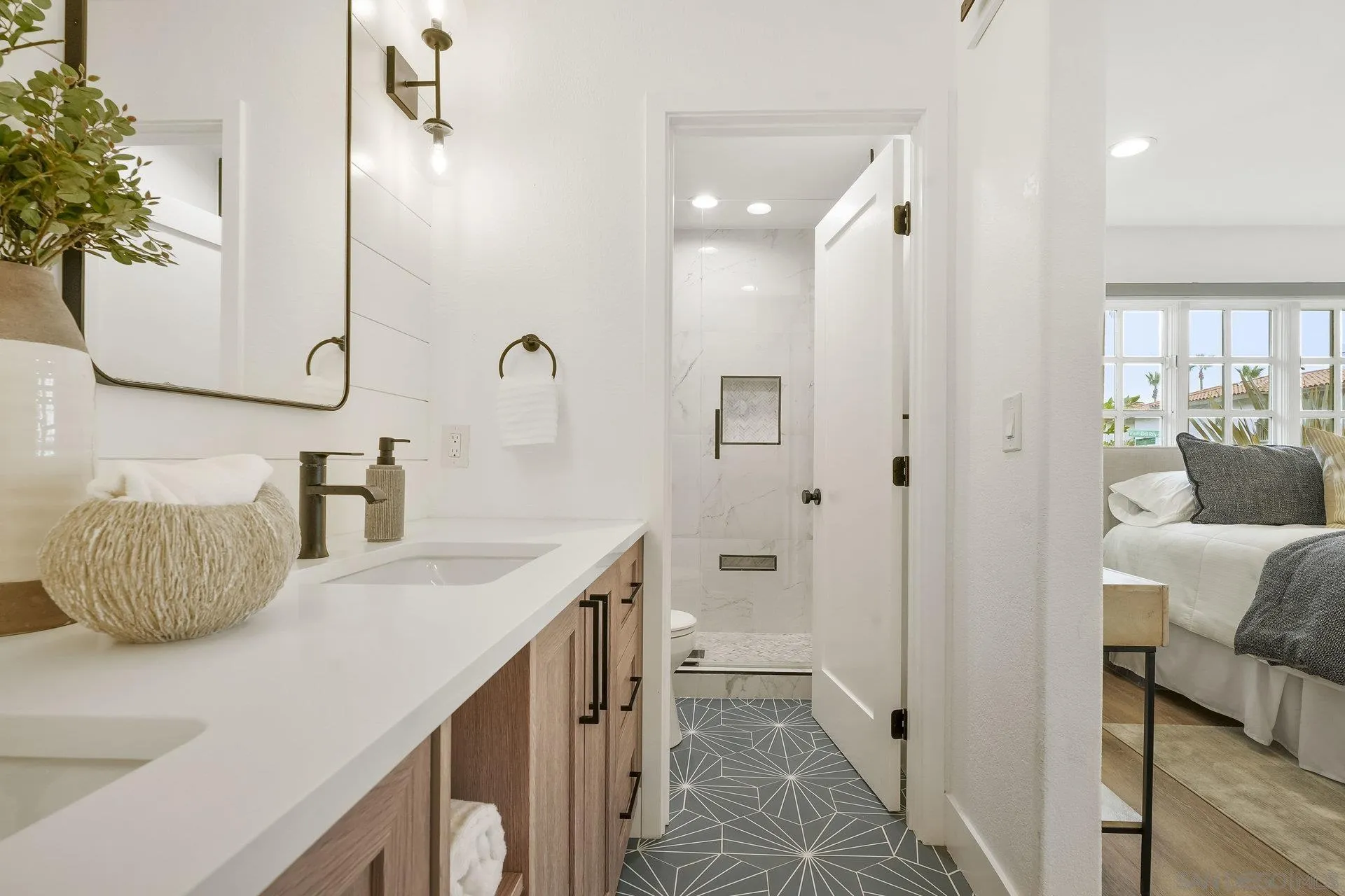 381 Playa Blanca Encinitas, CA 92024 - Photo 19 of 32 a bathroom with a sink and a mirror
