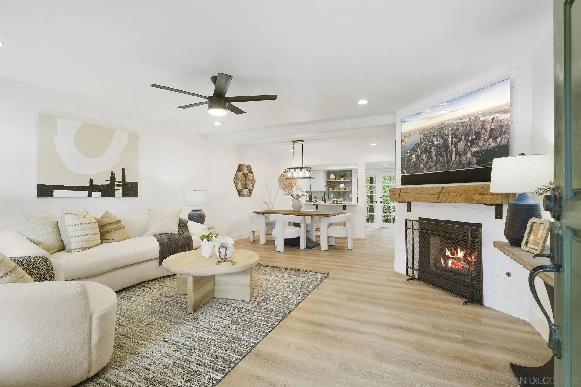 381 Playa Blanca Encinitas, CA 92024 - Photo 3 of 32 a living room with furniture a fireplace and a table