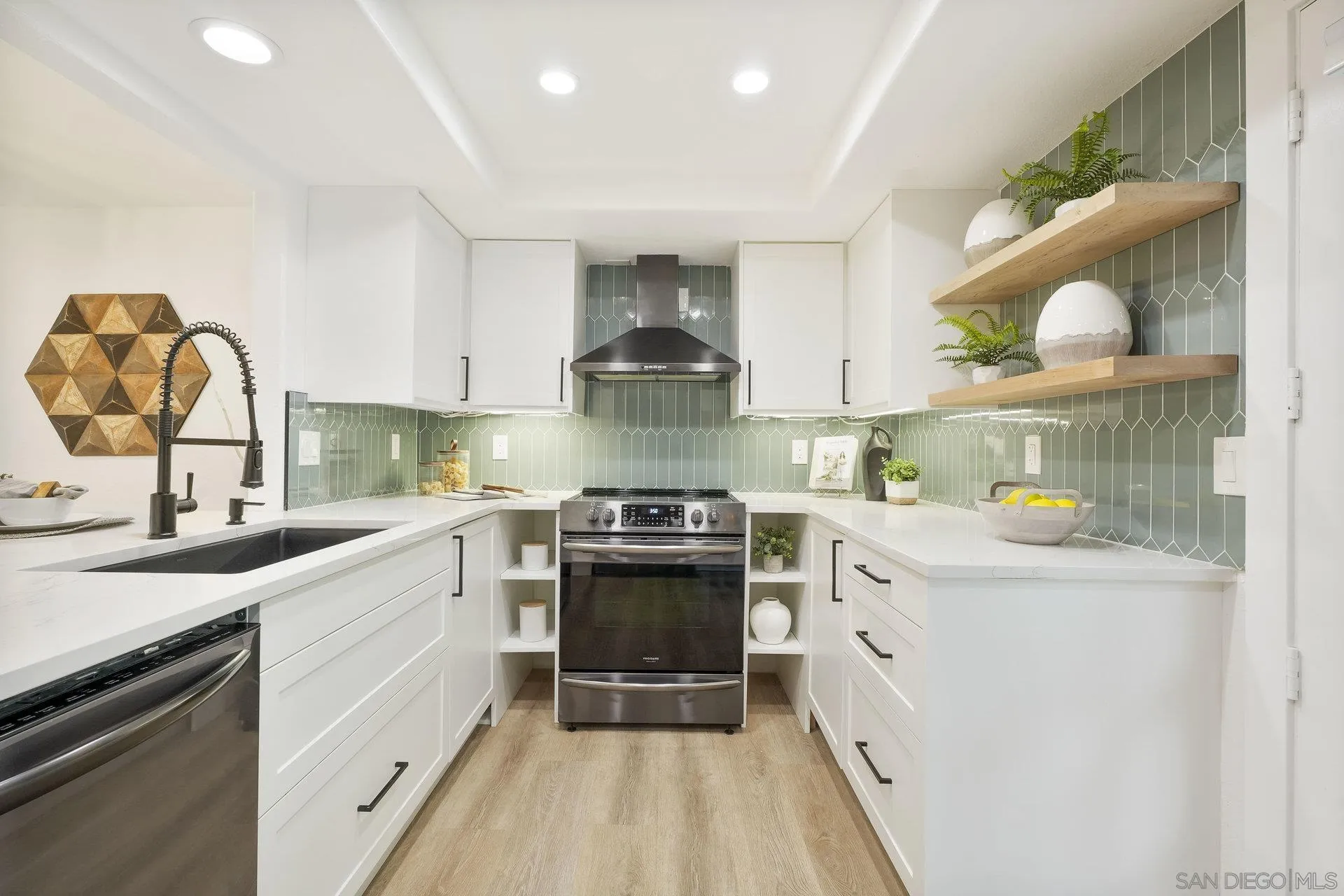 381 Playa Blanca Encinitas, CA 92024 - Photo 4 of 32 a kitchen with stainless steel appliances a stove sink and cabinets