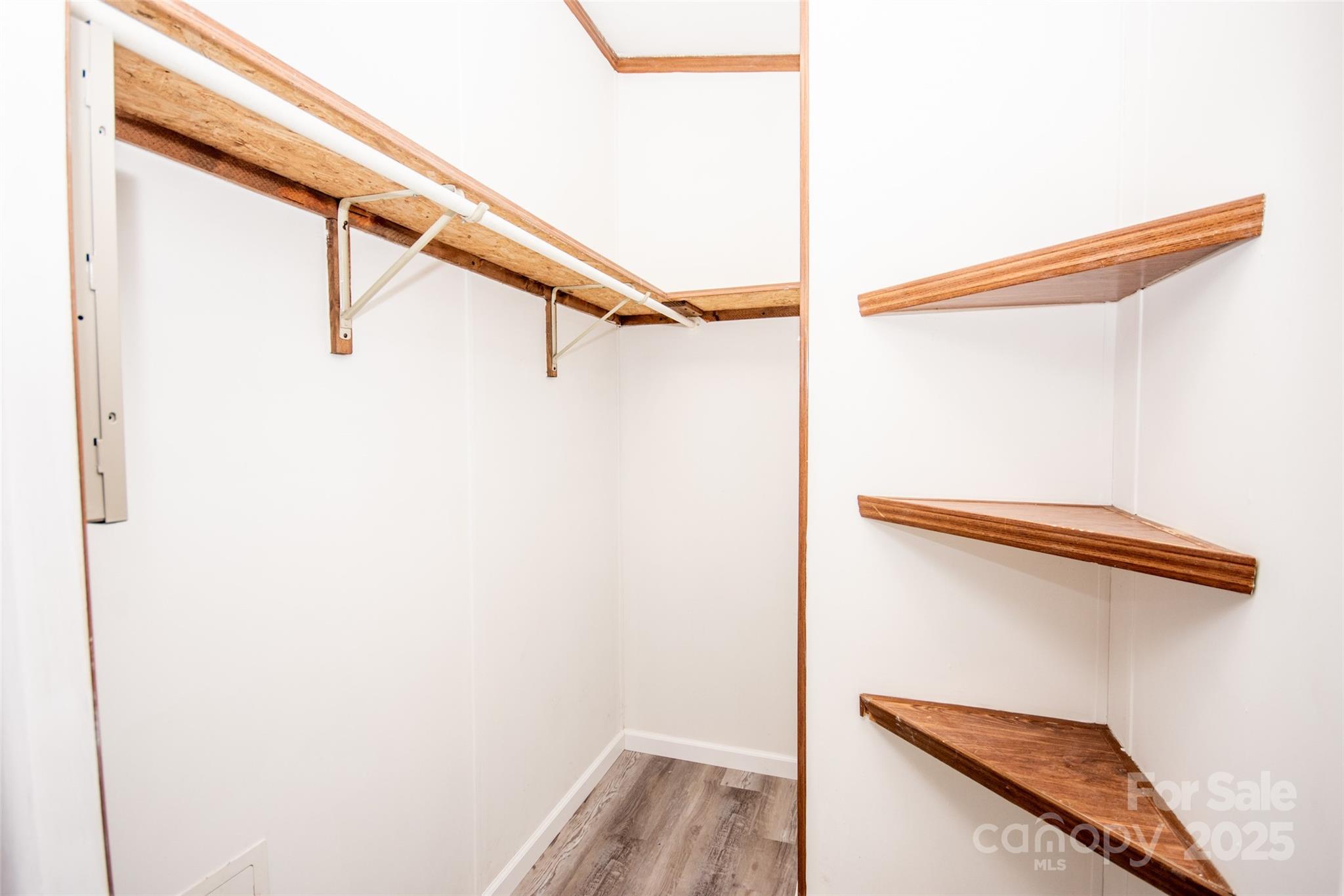 943 Tabor Road Olin, NC 28660 - Photo 15 of 31 a view of walk in closet with clothes and shoes