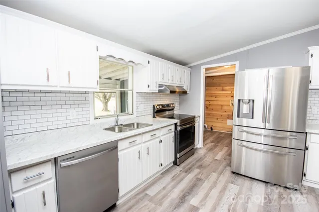 a kitchen with a sink stove and refrigerator