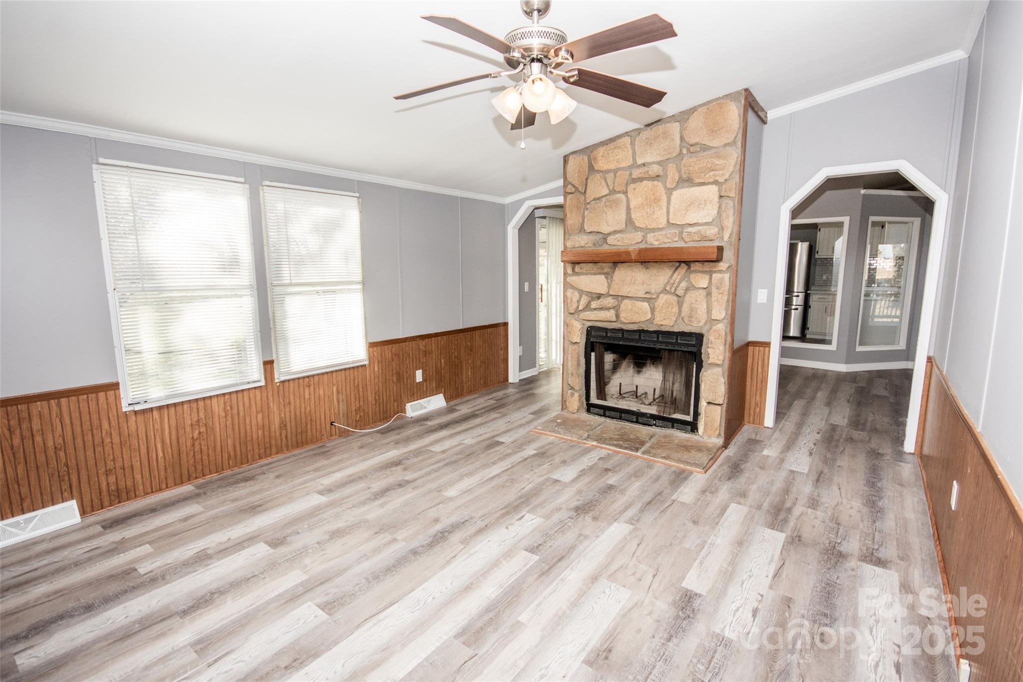 943 Tabor Road Olin, NC 28660 - Photo 24 of 31 a view of an empty room with wooden floor fireplace and a window