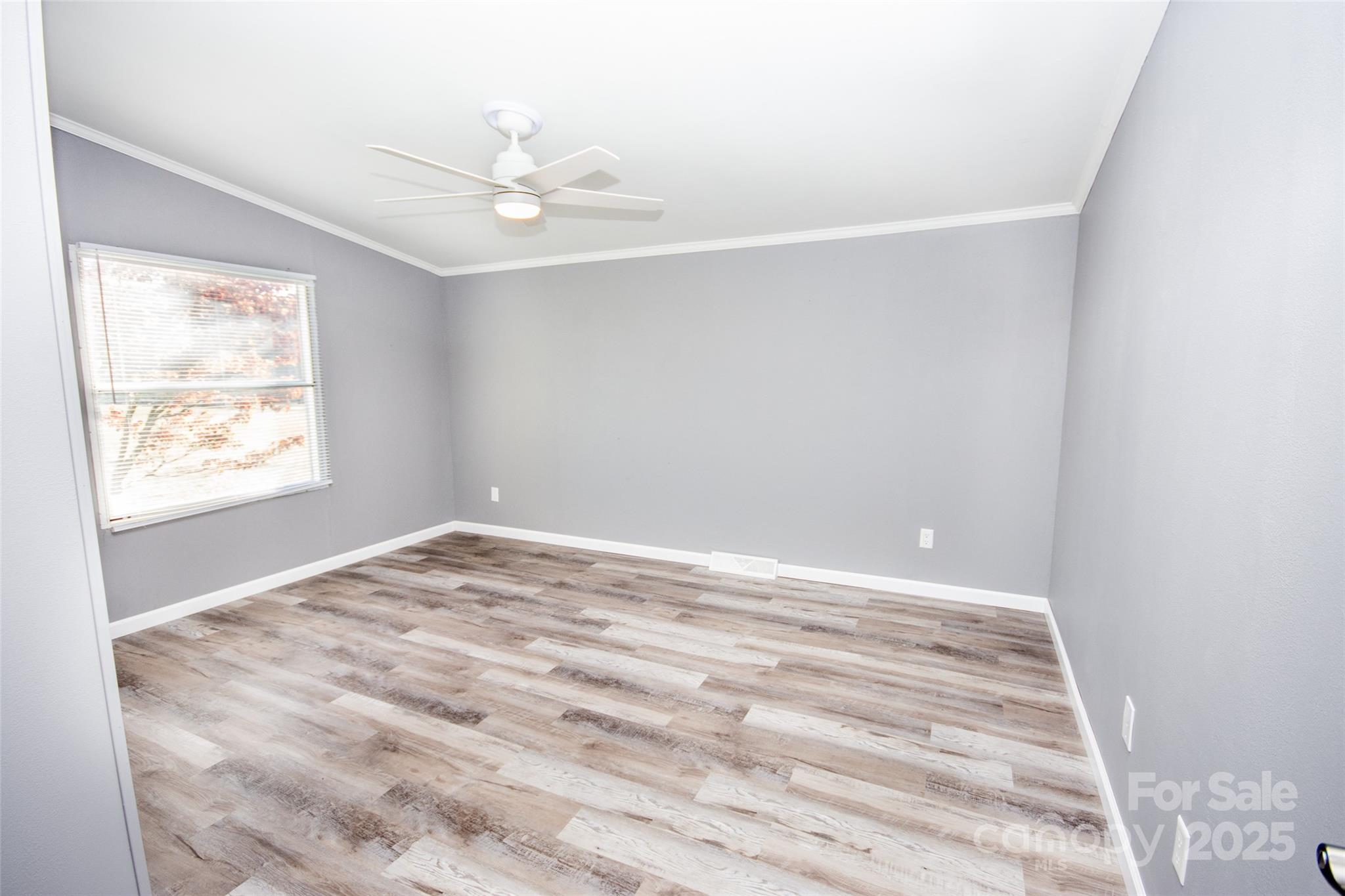 943 Tabor Road Olin, NC 28660 - Photo 28 of 31 a view of empty room with wooden floor and fan