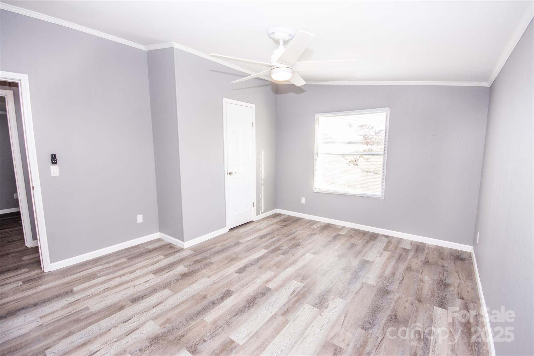 943 Tabor Road Olin, NC 28660 - Photo 29 of 31 a view of an empty room with window and wooden floor